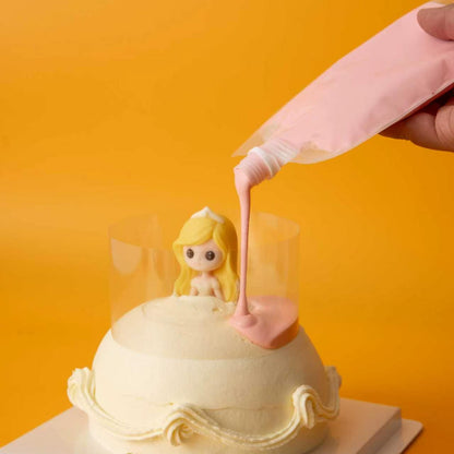 Pouring pink glaze onto the Pour & Sprinkle Princess Cake